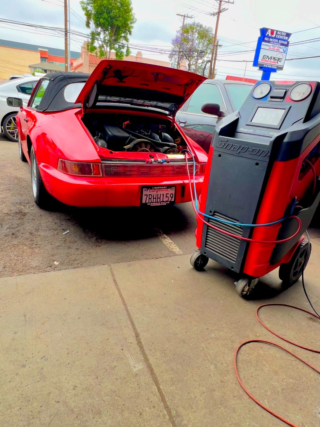 Red Porsche 911 Targa being serviced