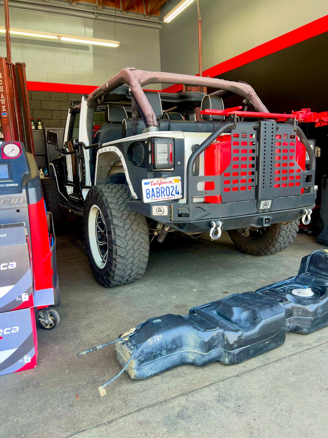 Jeep Wrangler on a lift with fuel tank removed