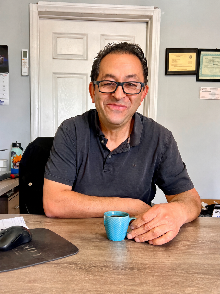All Model Repair shop owner with an espresso