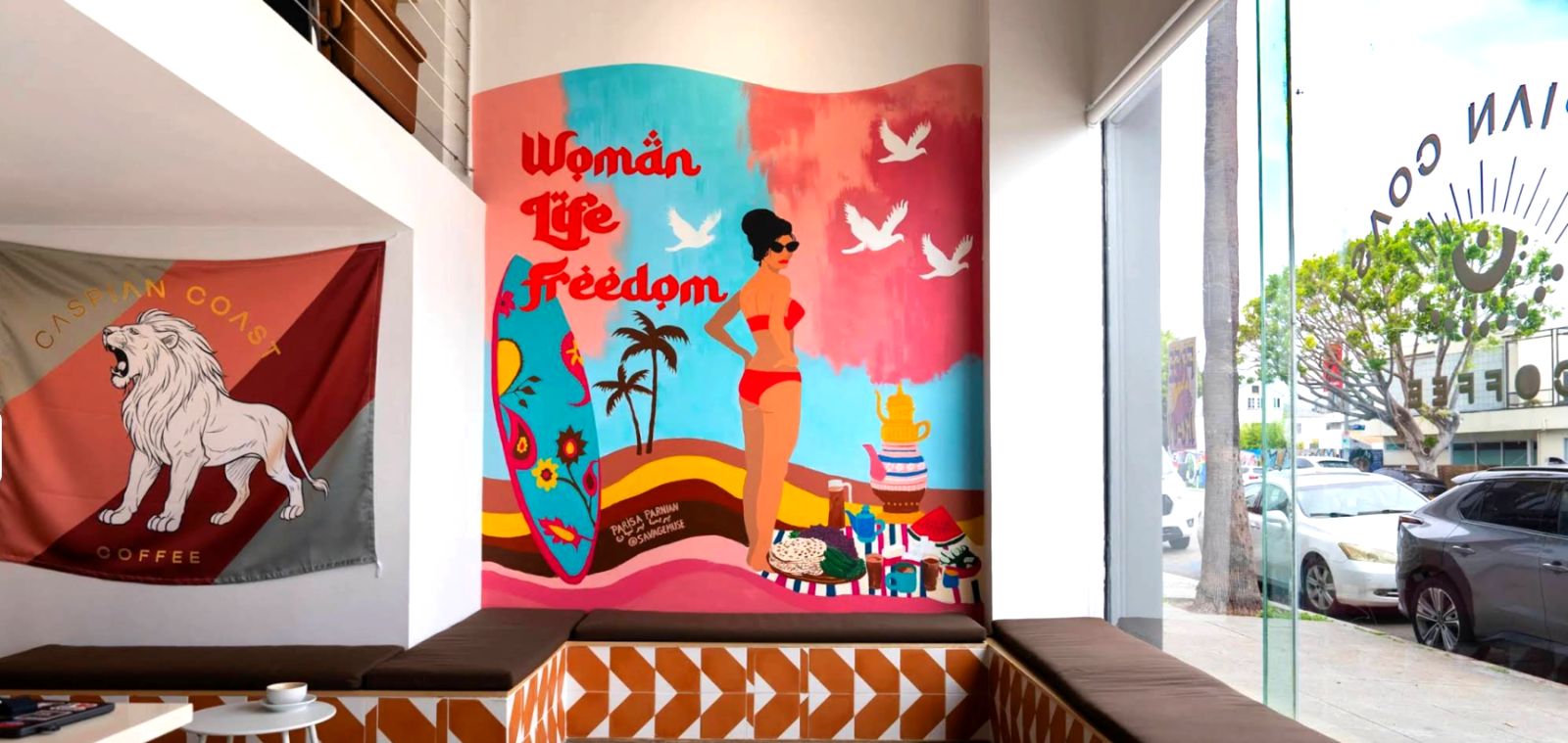 Woman Life Freedom mural and Caspian Coast lion flag